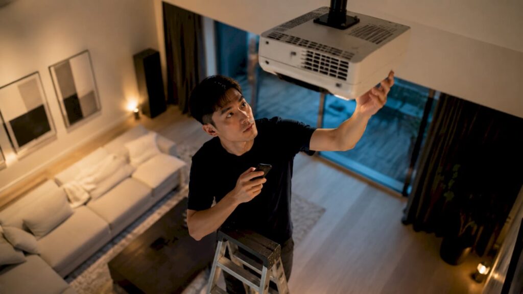 Tech enthusiast adjusting home theater projector